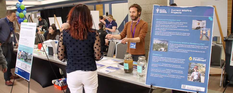 people at a booth at an open house event
